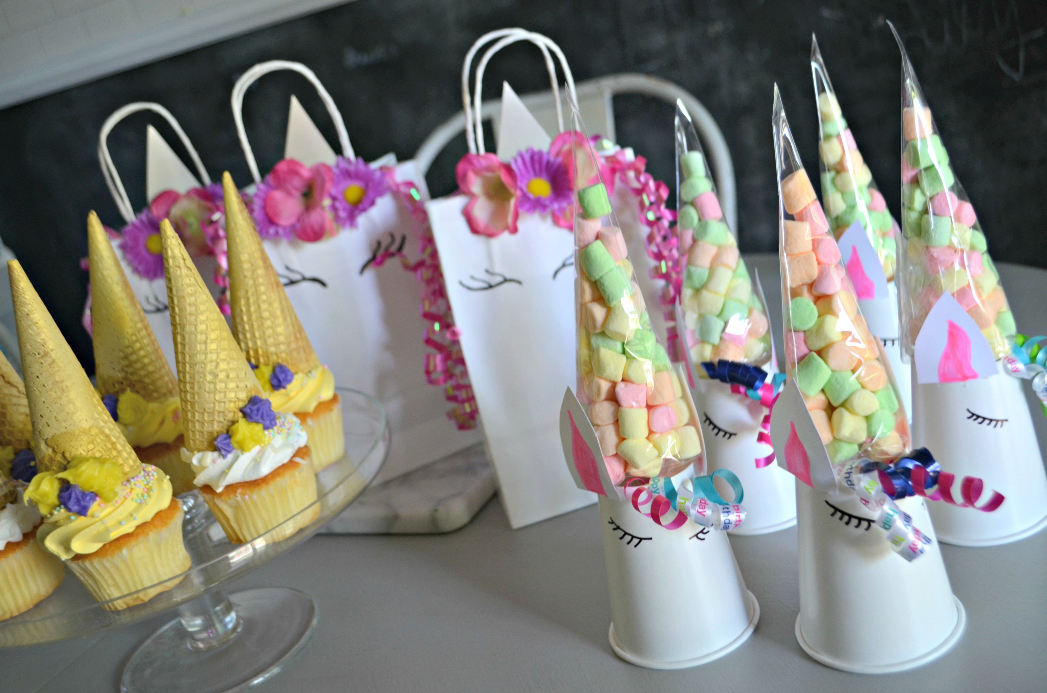unicorn birthday party cupcakes with goody bags and marshmallows