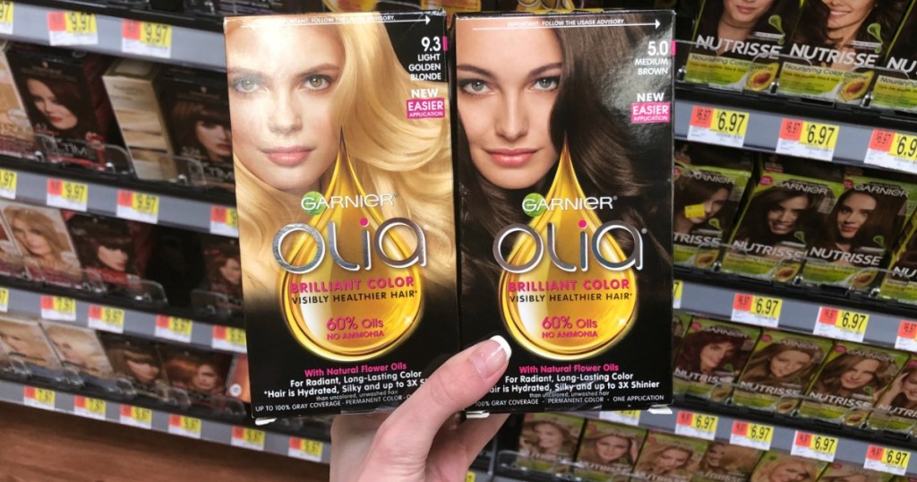 hand holding two boxes of Garnier olia