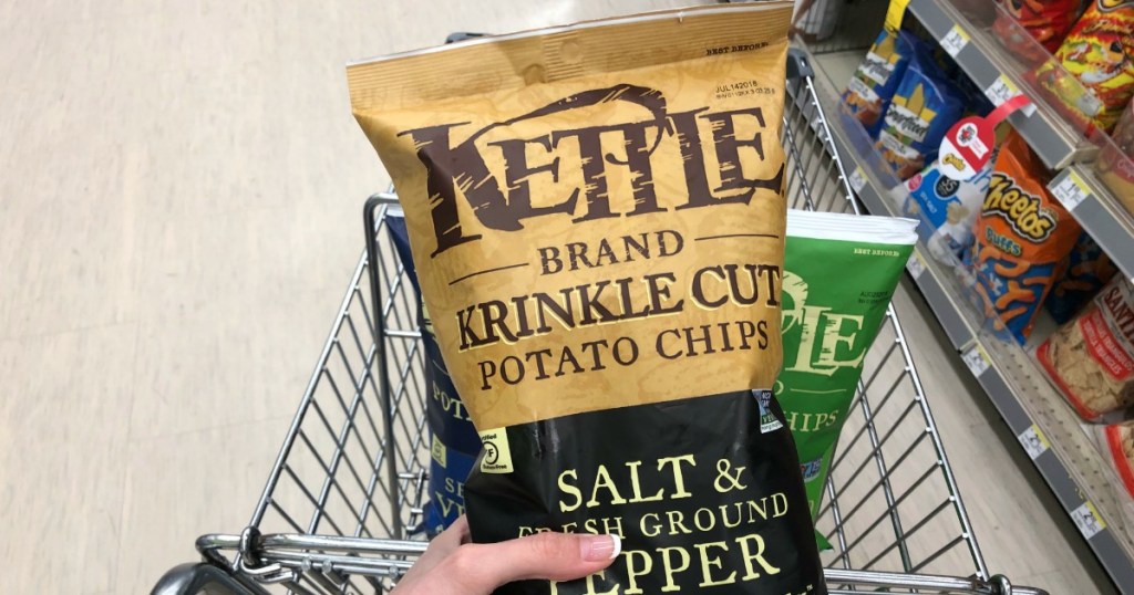 holding a bag of Kettle Chips
