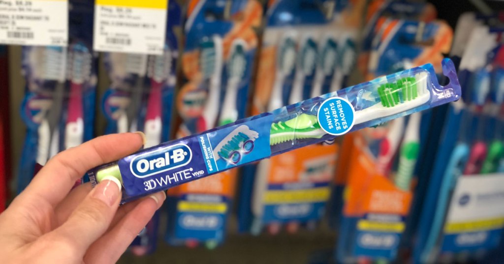 hand holding an Oral-B toothbrush