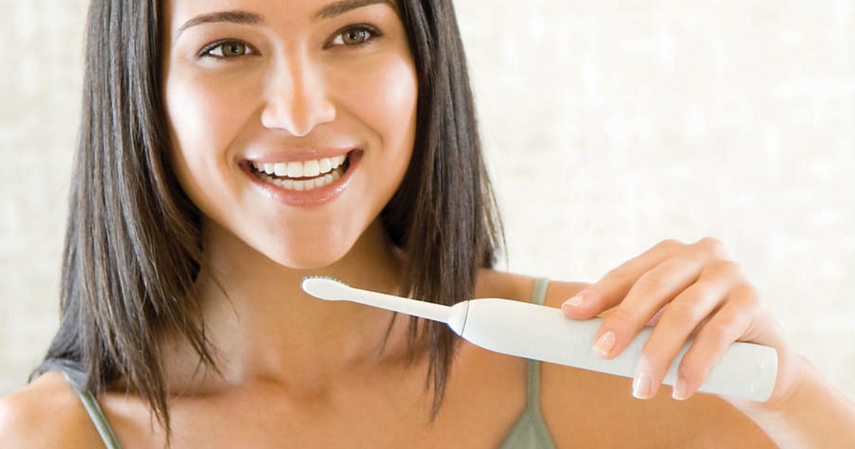 woman brushing teeth with philips sonicare toothbrush