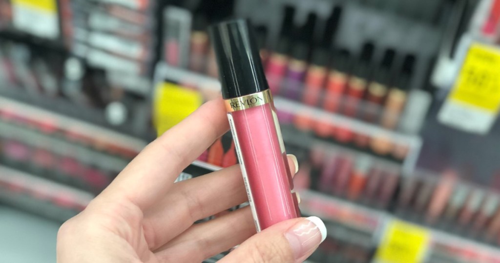 hand holding revlon pink lip gloss 