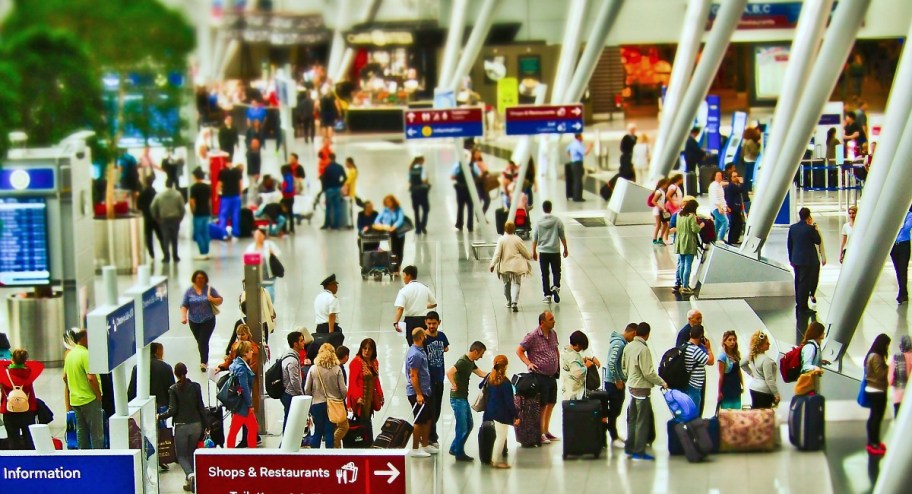 busy airport with people in line for security