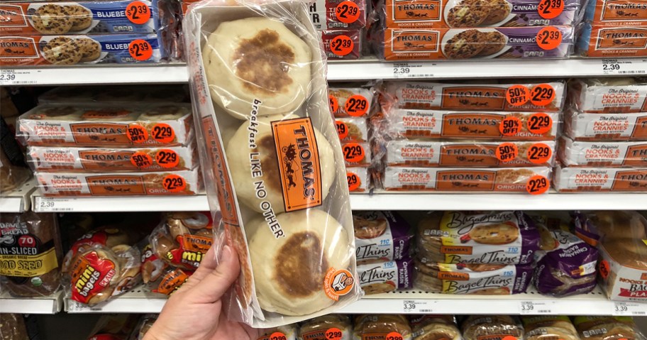 Hand holding a package of Thomas English muffins