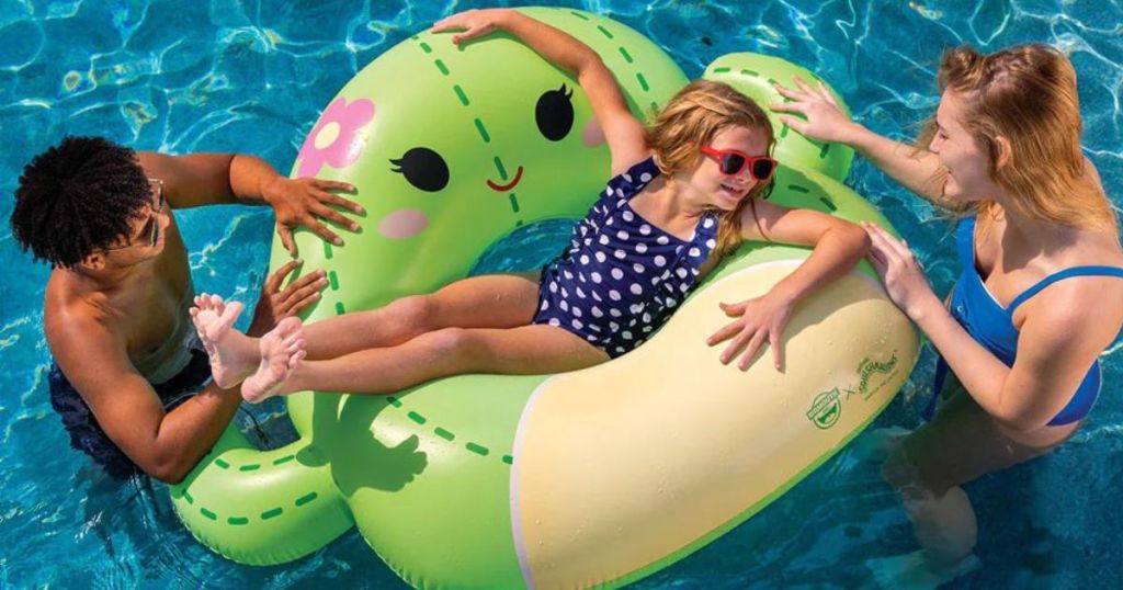Little girl laying in a squishmallows cactus float