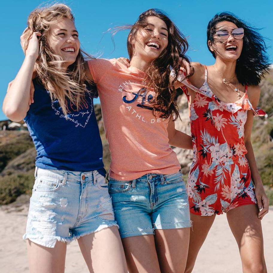 3 women on a beach wearing Aeropostale Shorts