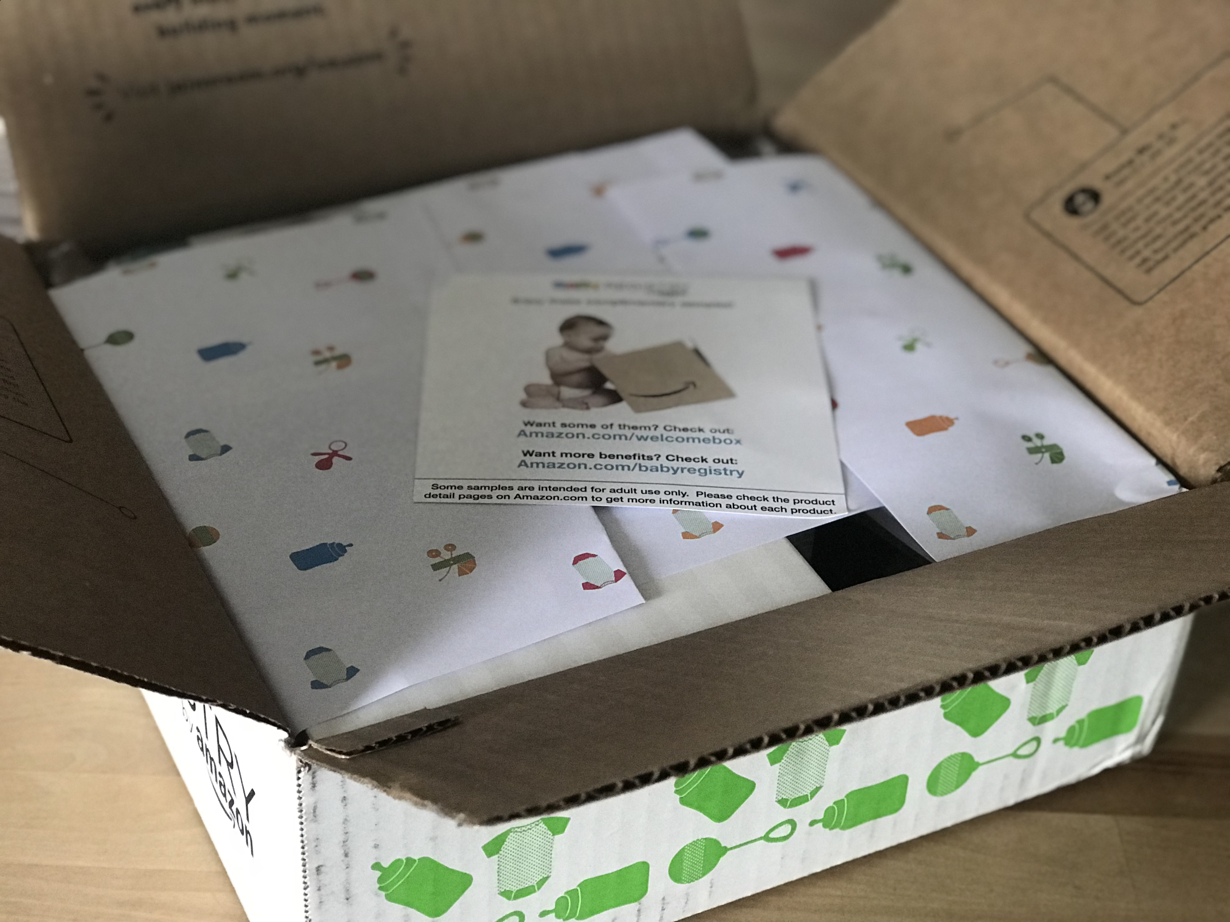 free amazon baby welcome box - Box opened, with wrapping and a welcome card on top
