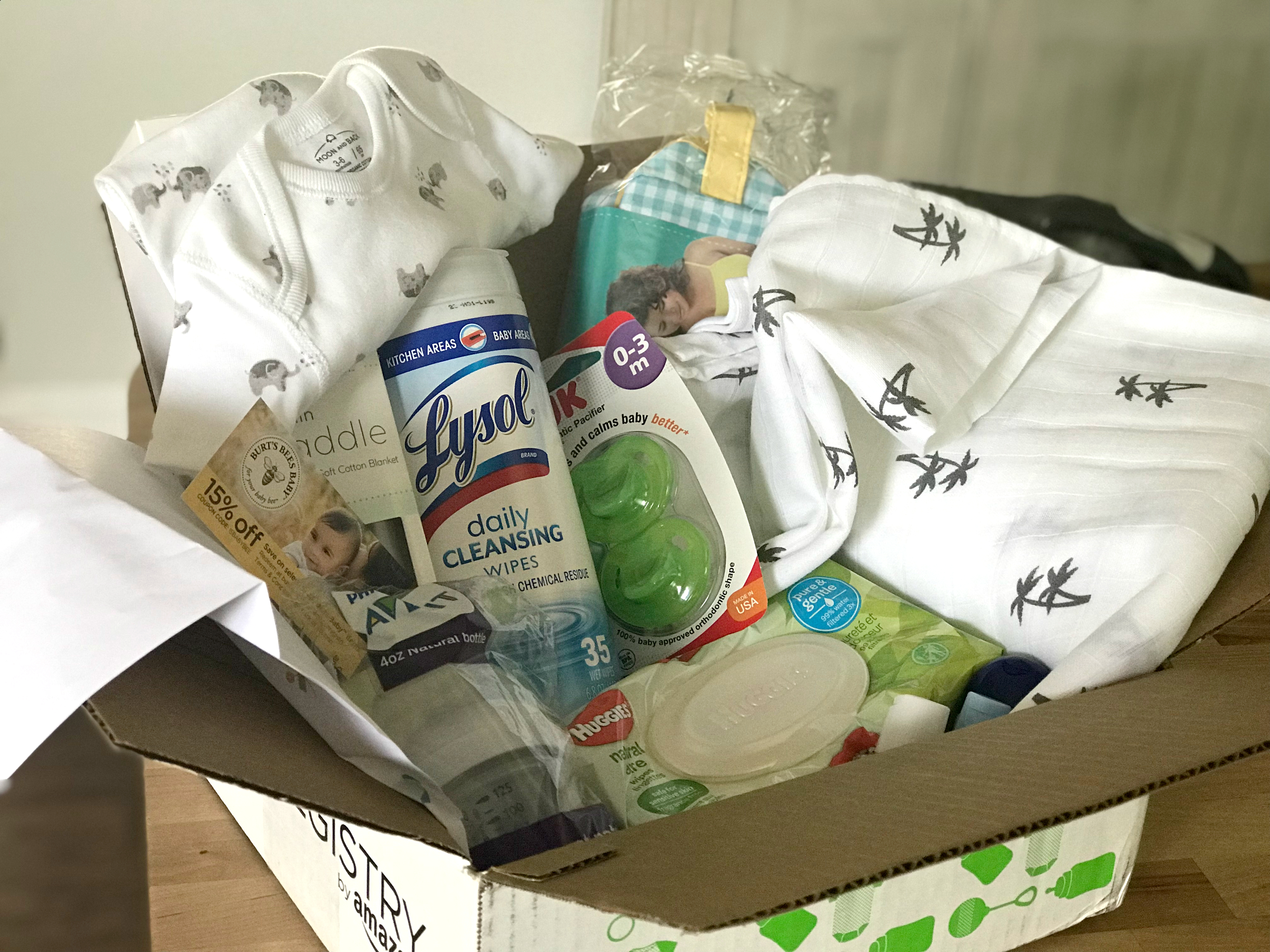 free amazon baby welcome box - Box opened, showing wipes, a onesie, diapers, pacifiers, and more