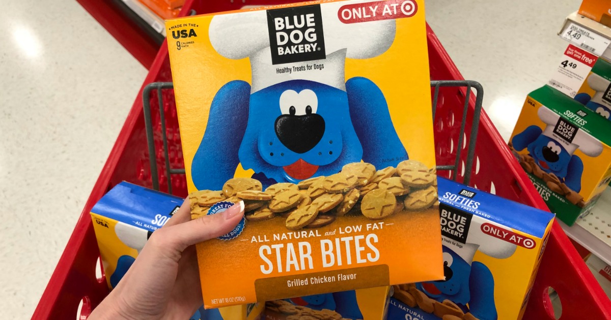 hand holding up box of blue dog bakery dog treats