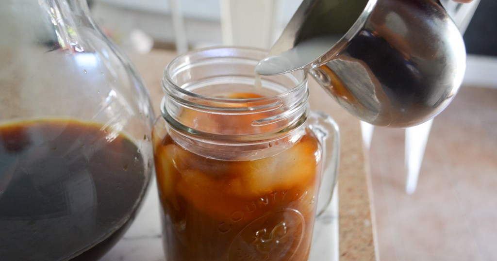 pouring in creamer to cold brew coffee
