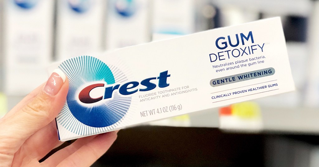 woman holding Crest Gum Detoxify