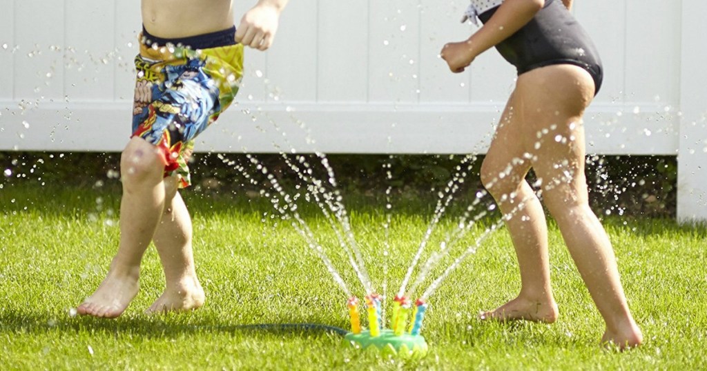 kids running thru a melissa and doug sprinkler