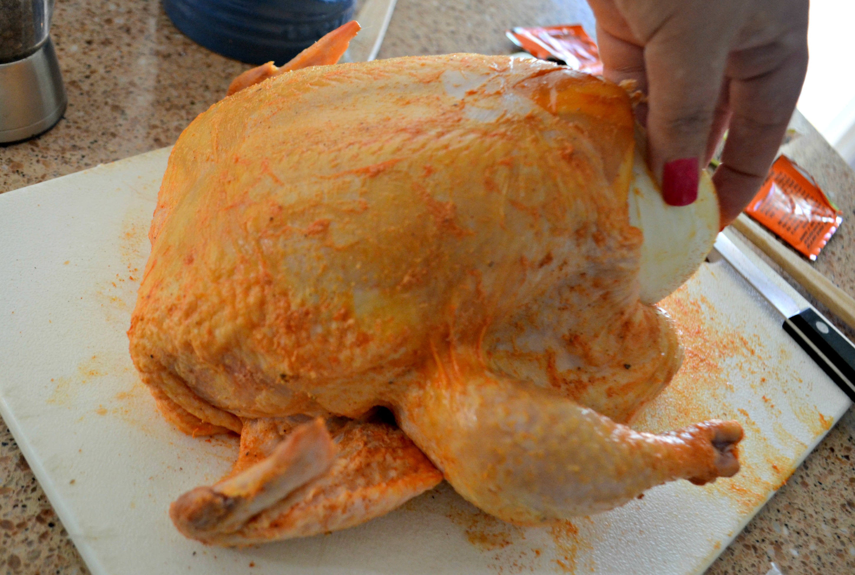 cook a whole chicken in the air fryer in about an hour - stuffing chicken with onion