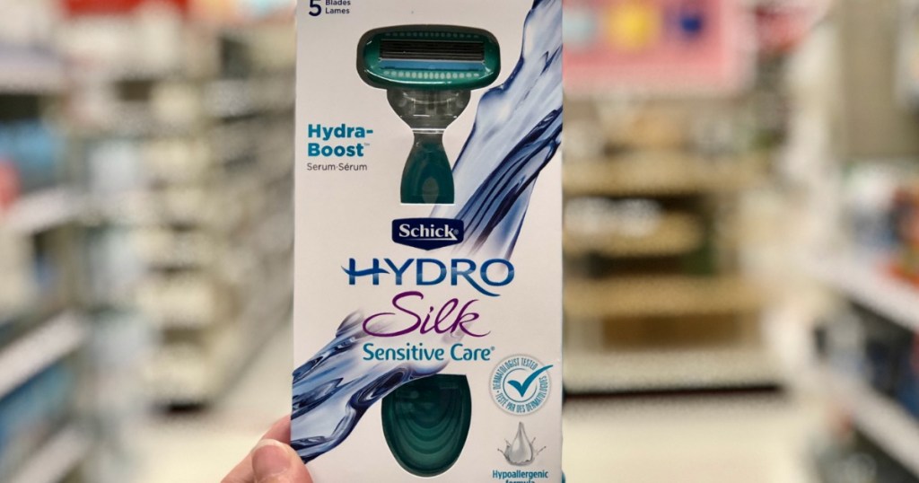 hand holding up a schick hydro silk razor in a store aisle