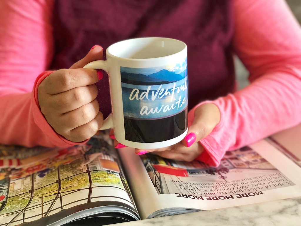 woman holding a Shutterfly photo mug while reading a magazine