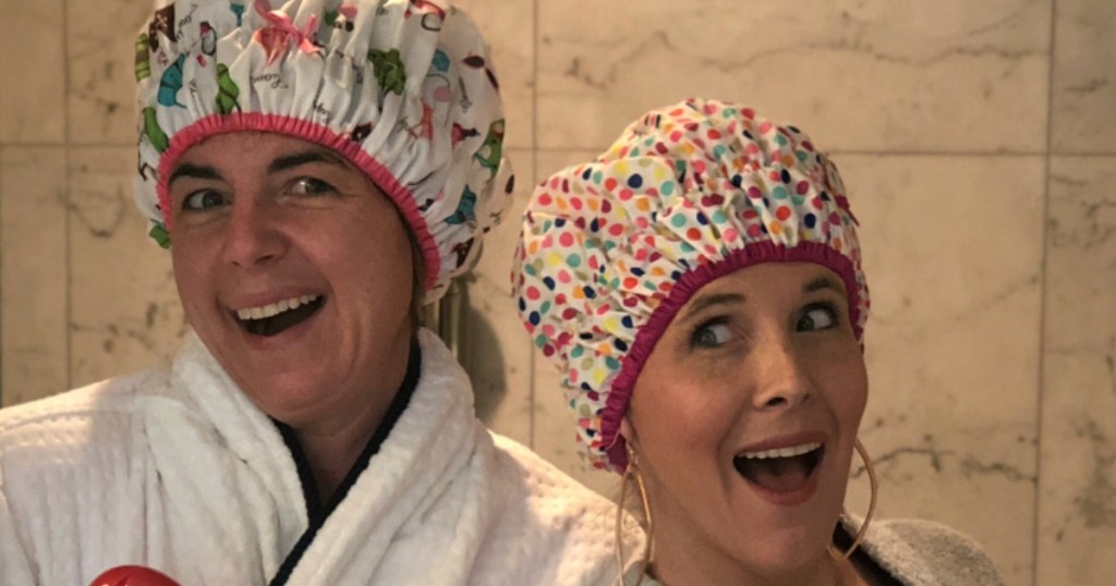 two woman wearing shower caps 