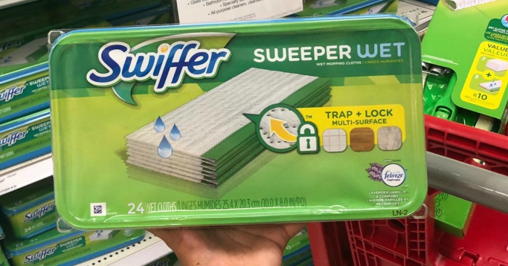 package of wet mopping cloths swiffer sweeper refills held near a target cart and shelf