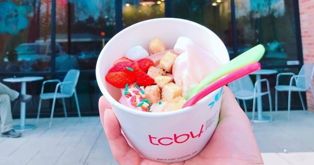 TCBY Frozen Yogurt with sprinkles, cheesecake bites, marshmallows, and a spoon