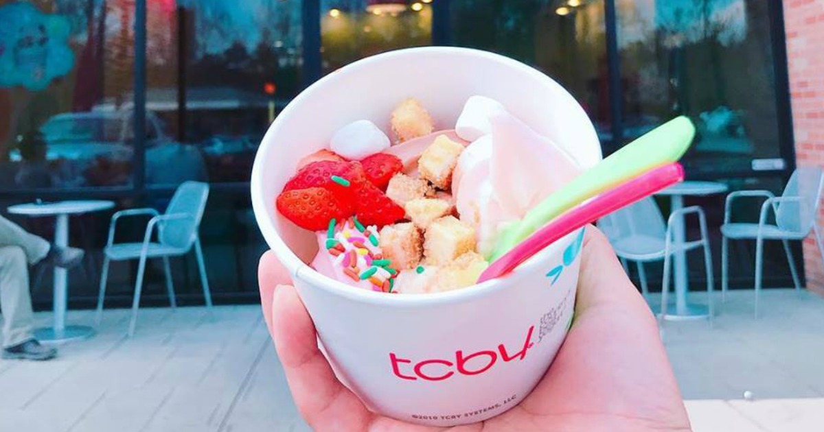 TCBY Frozen Yogurt with candy toppings held in hand 