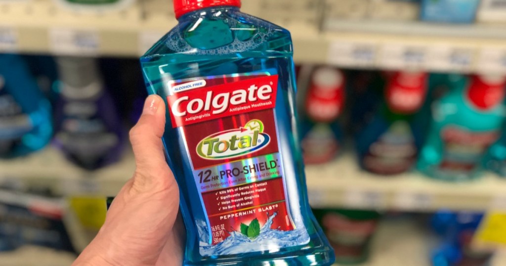 hand holding bottle of Colgate mouthwash