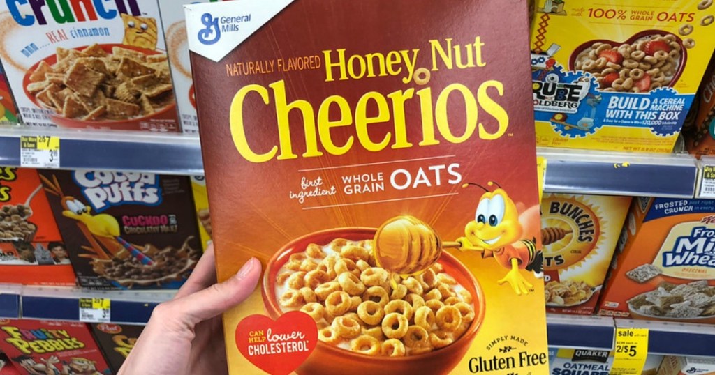 holding a box of Honey Nut Cheerios