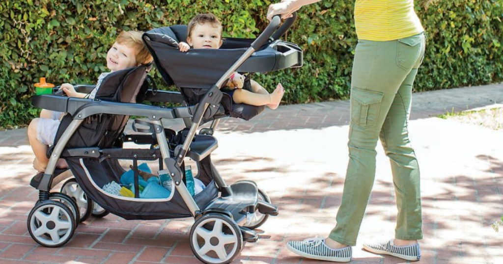 woman pushing stroller with two kids