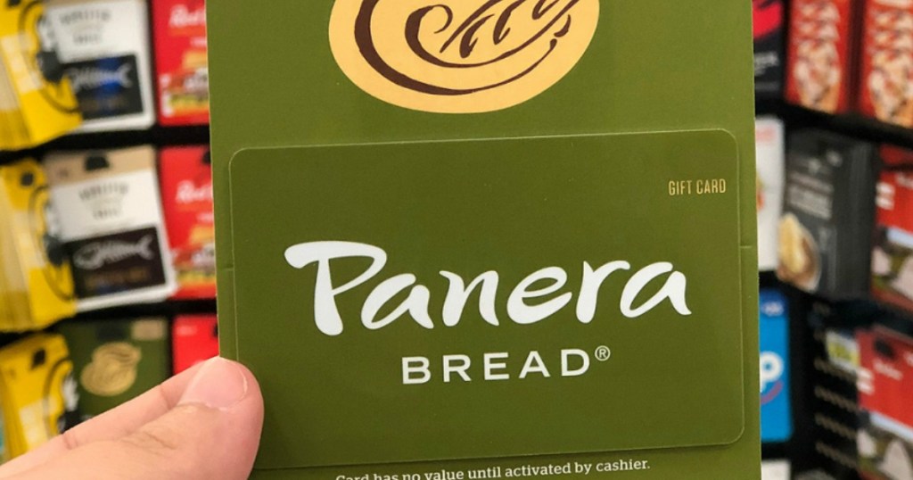 hand holding panera gift card in store