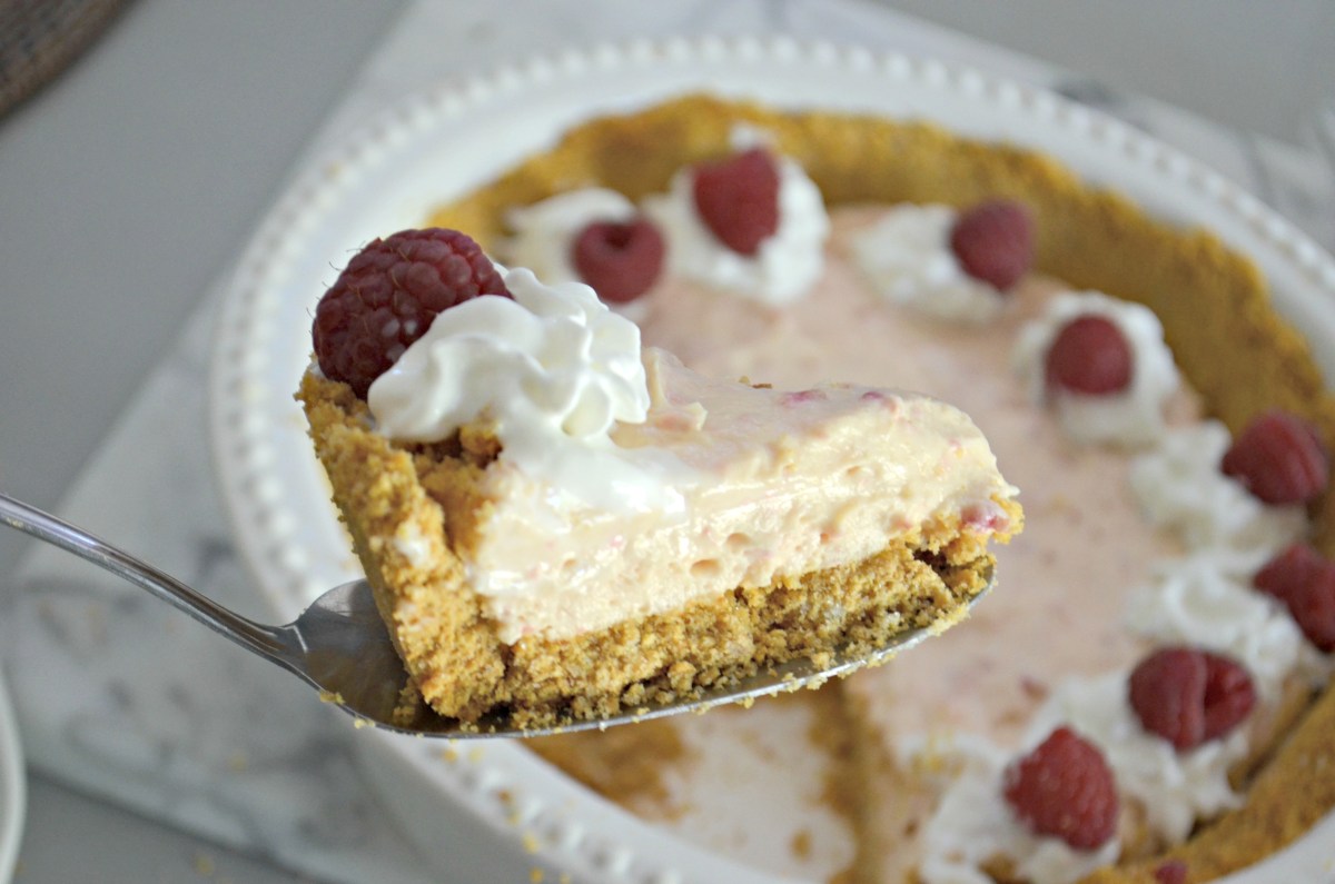 cutting a slice of raspberry pie