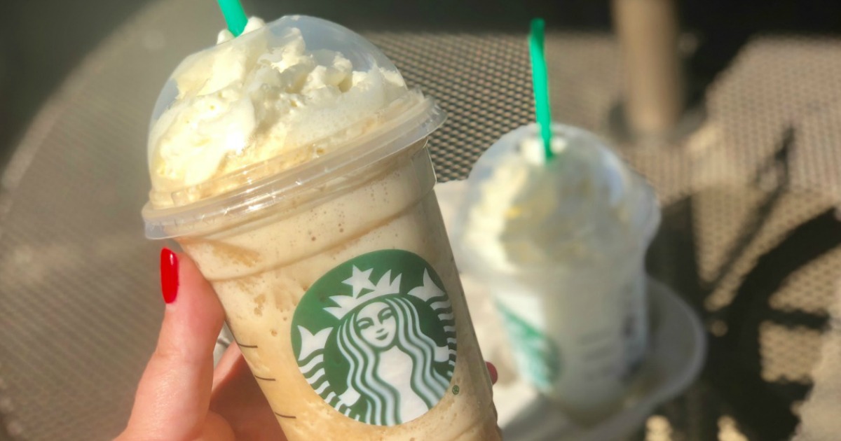 starbucks frozen beverage with whipped cream being held outside