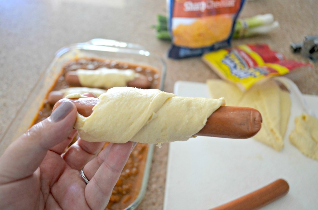 wrapping a hot dog in crescent roll