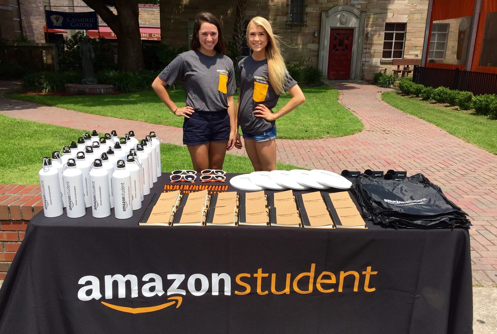 amazon college student giveaways - college students at a table giving away free items