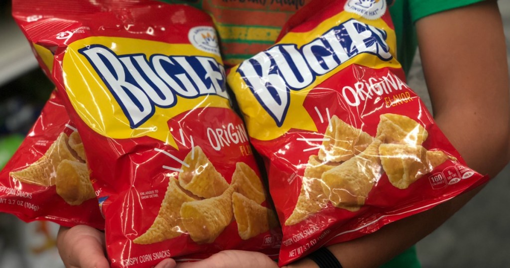 Person holding bags of Bugles snacks