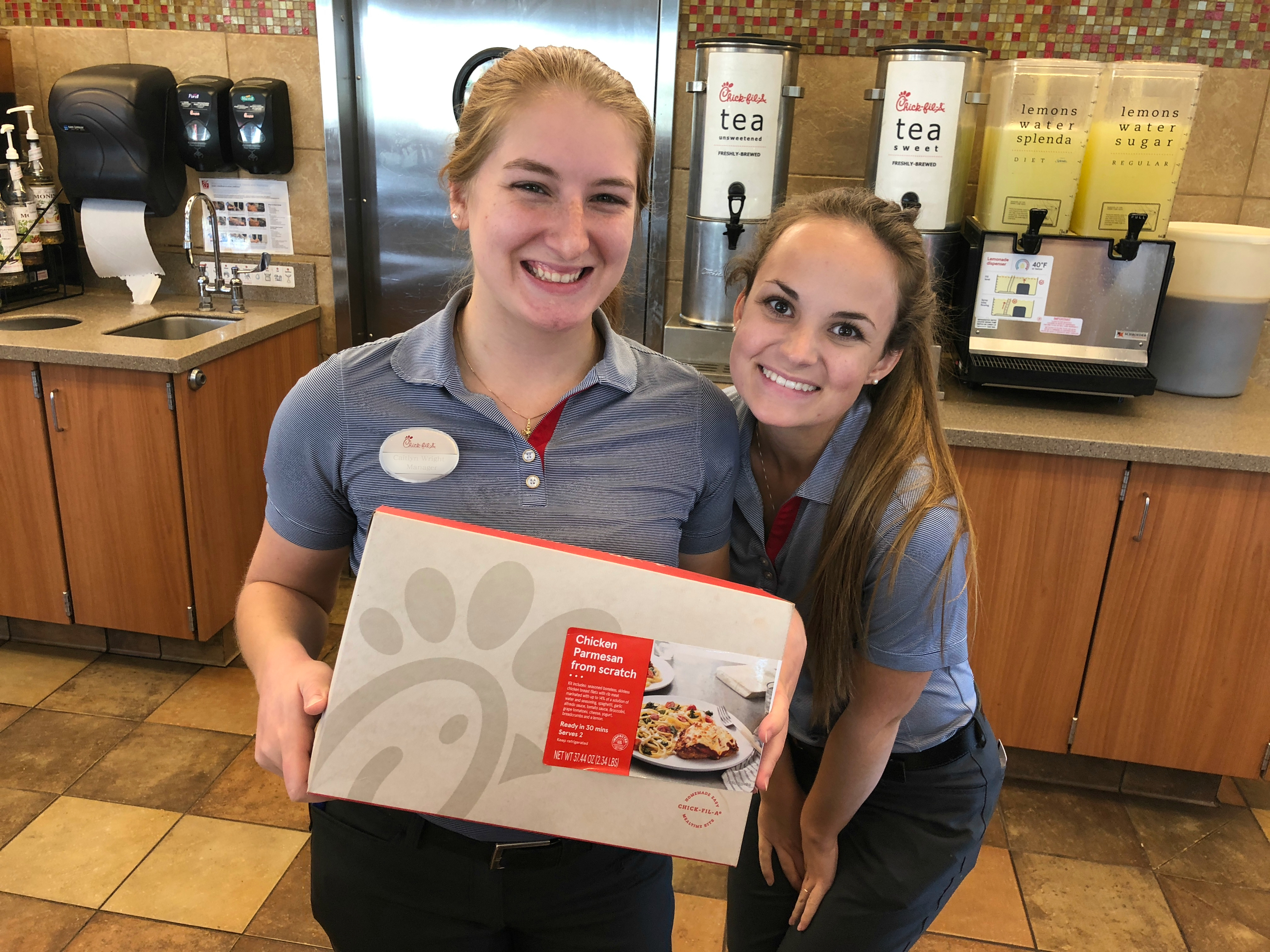 Chickfila employees show off one of the available meal kits