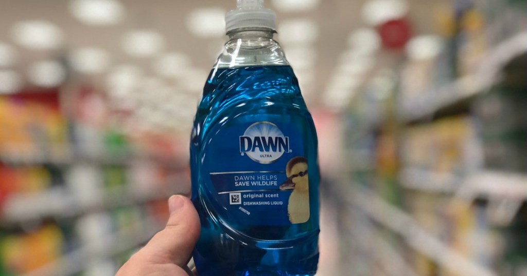 hand holding blue bottle of dish liquid