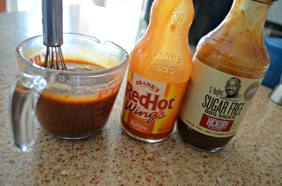 measuring cup with mix of hot sauce and bbq sauce for chicken wings in the Crock-Pot