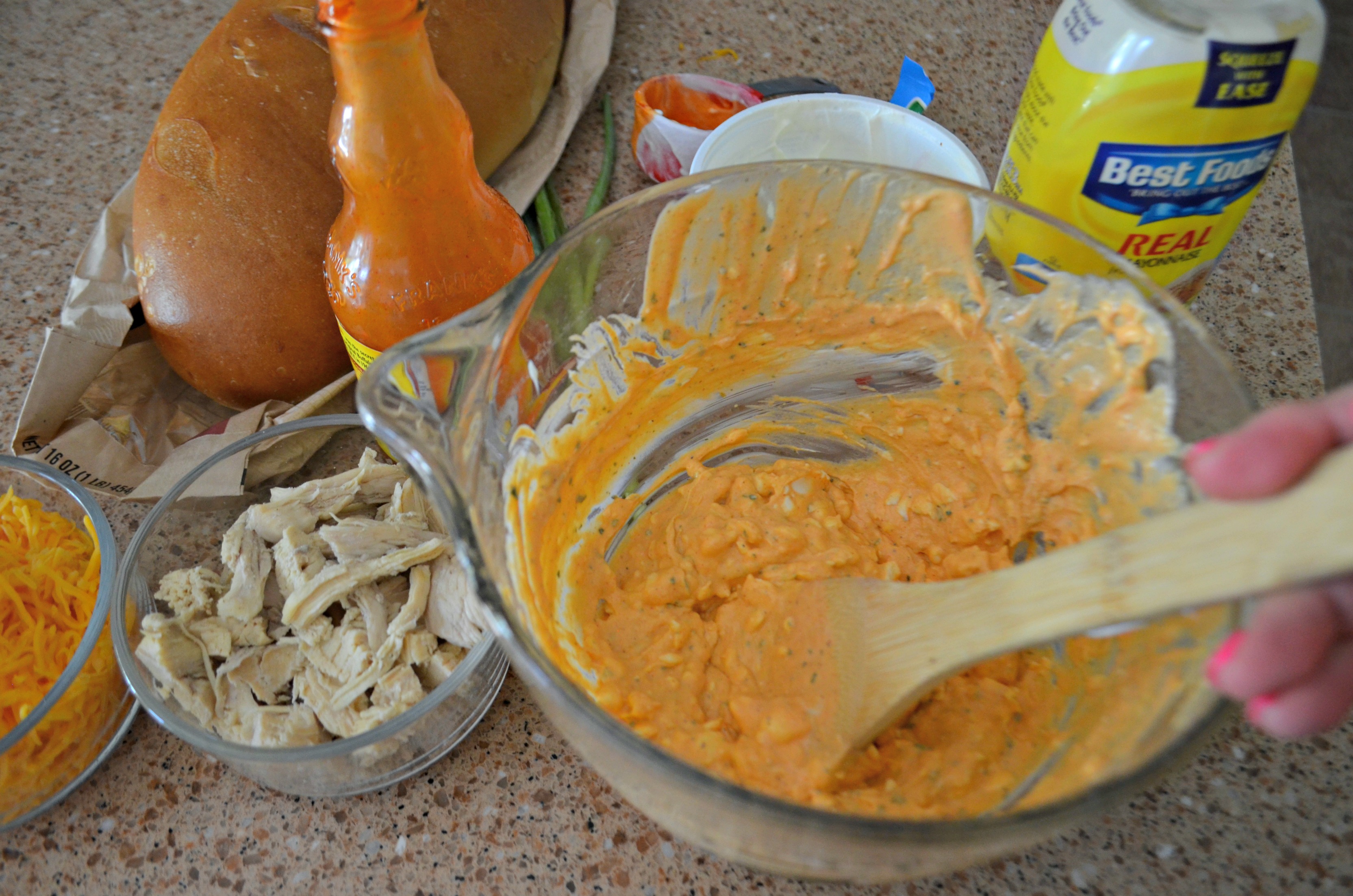 Buffalo Chicken Dip Bread Bowl - mixing the ingredients in a mixing bowl