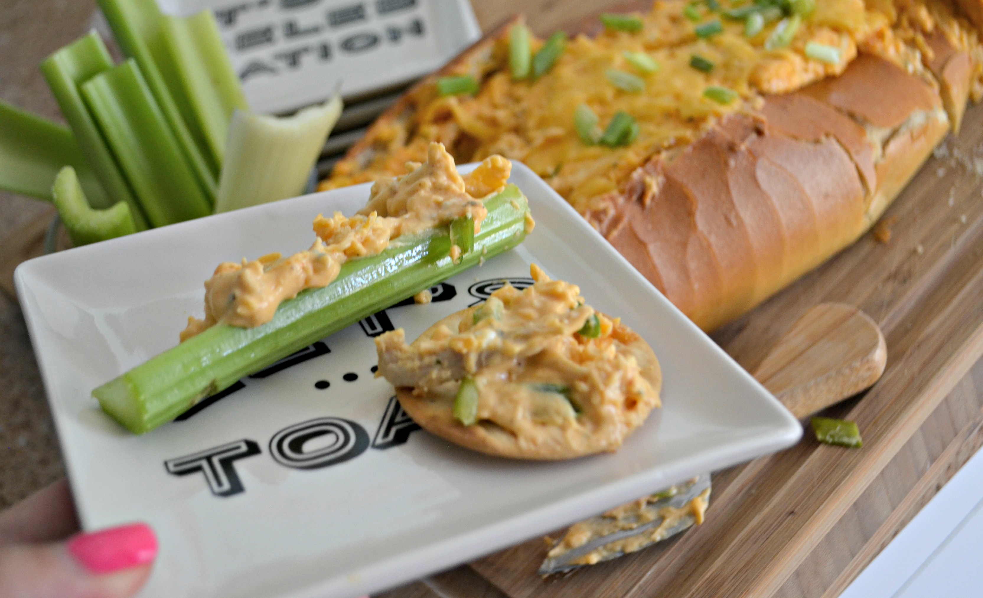 Buffalo Chicken Dip Bread Bowl - served on celery and a cracker