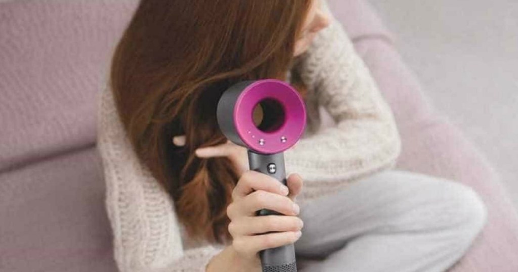 woman drying hair with Dyson hair dryer