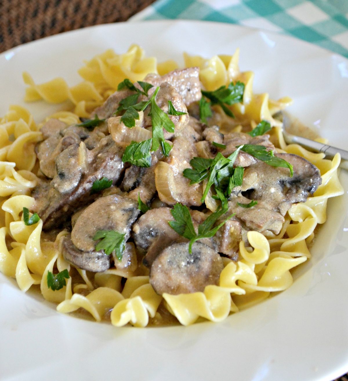 classic beef stroganoff is one of our favorite childhood recipes – plated with parsley