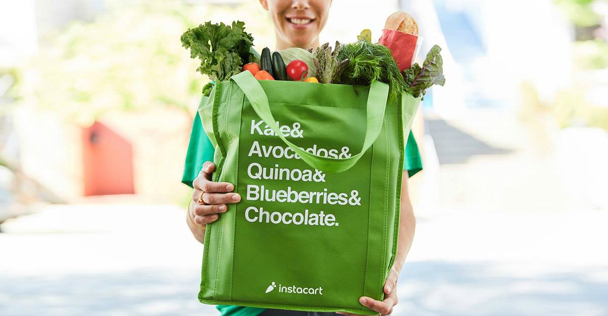 grocery services — instacart shopper holding bag of groceries