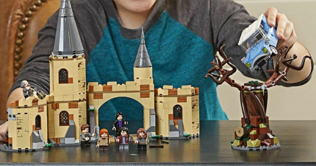 kid playing with the LEGO Harry Potter Hogwarts Whomping Willow