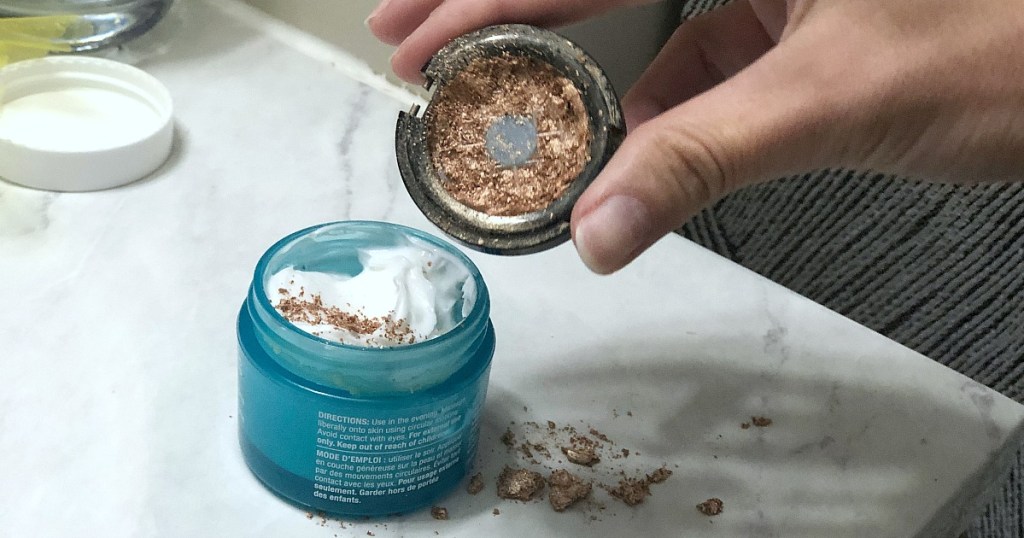 pouring broken shimmer powder makeup into lotion