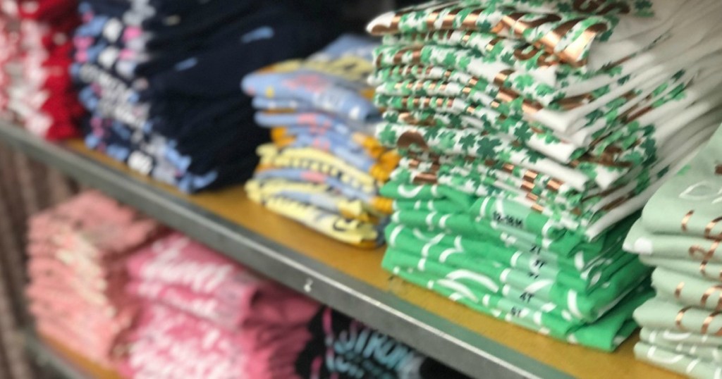 rows of Old Navy girls shirts on a table