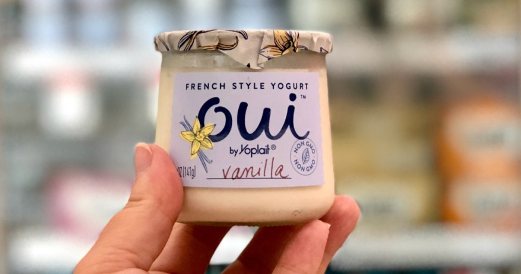 hand holding container of Oui yogurt