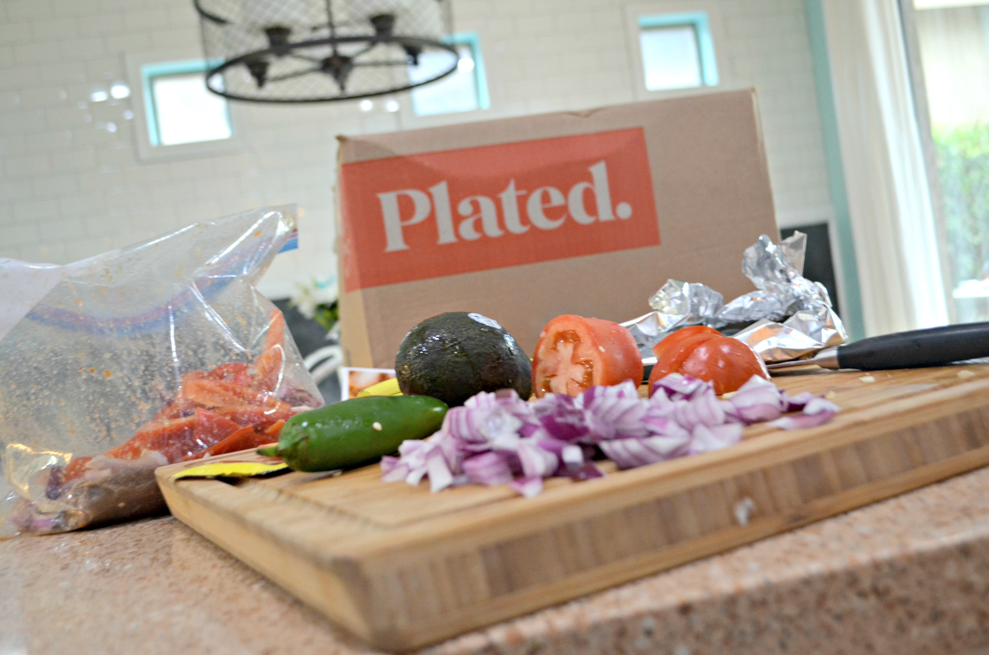 deal plated meal kit – Plated subscription box ingredients on a kitchen counter.
