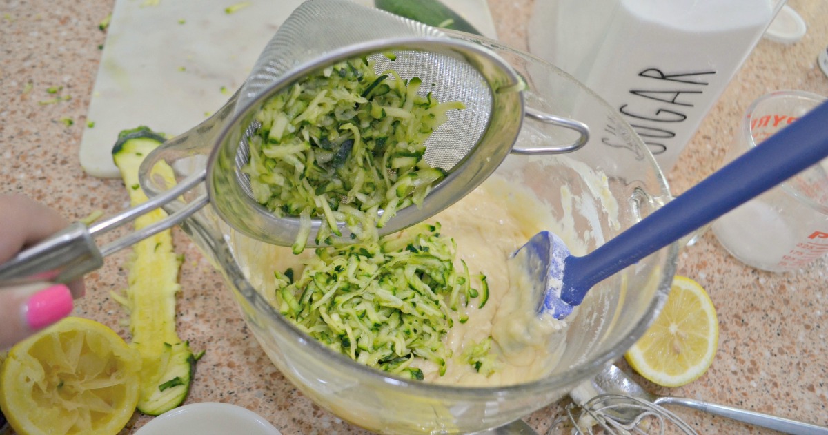pouring zucchini in lemon zucchini bread batter