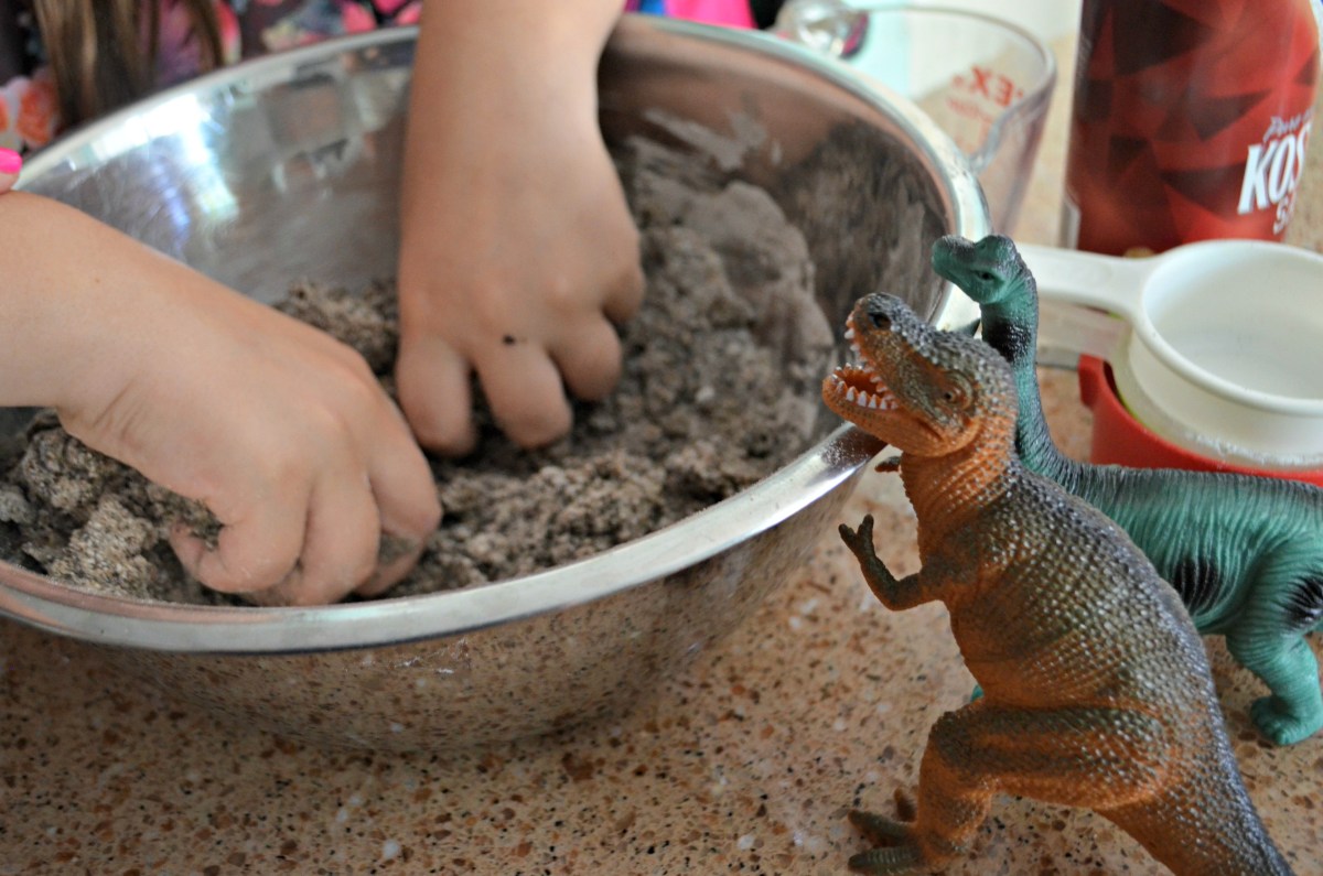 kneading the ingredients for DIY dinosaur eggs 
