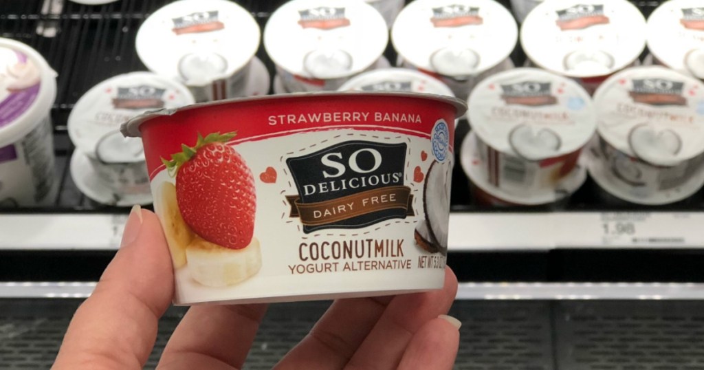hand holding single-serve yogurt in a store
