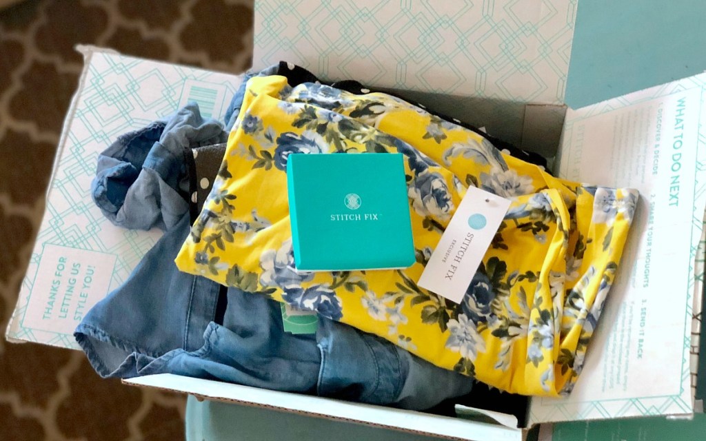 open stitch fix box with clothes and jewelry box