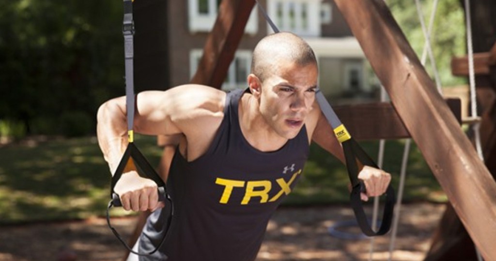 Man working out with TRX trainer straps